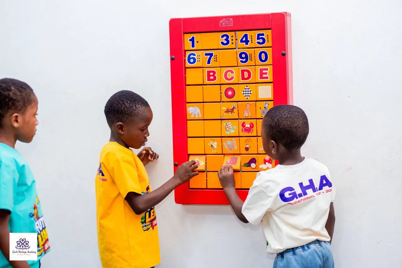 Pupils working out numbers and letters on a wall puzzle